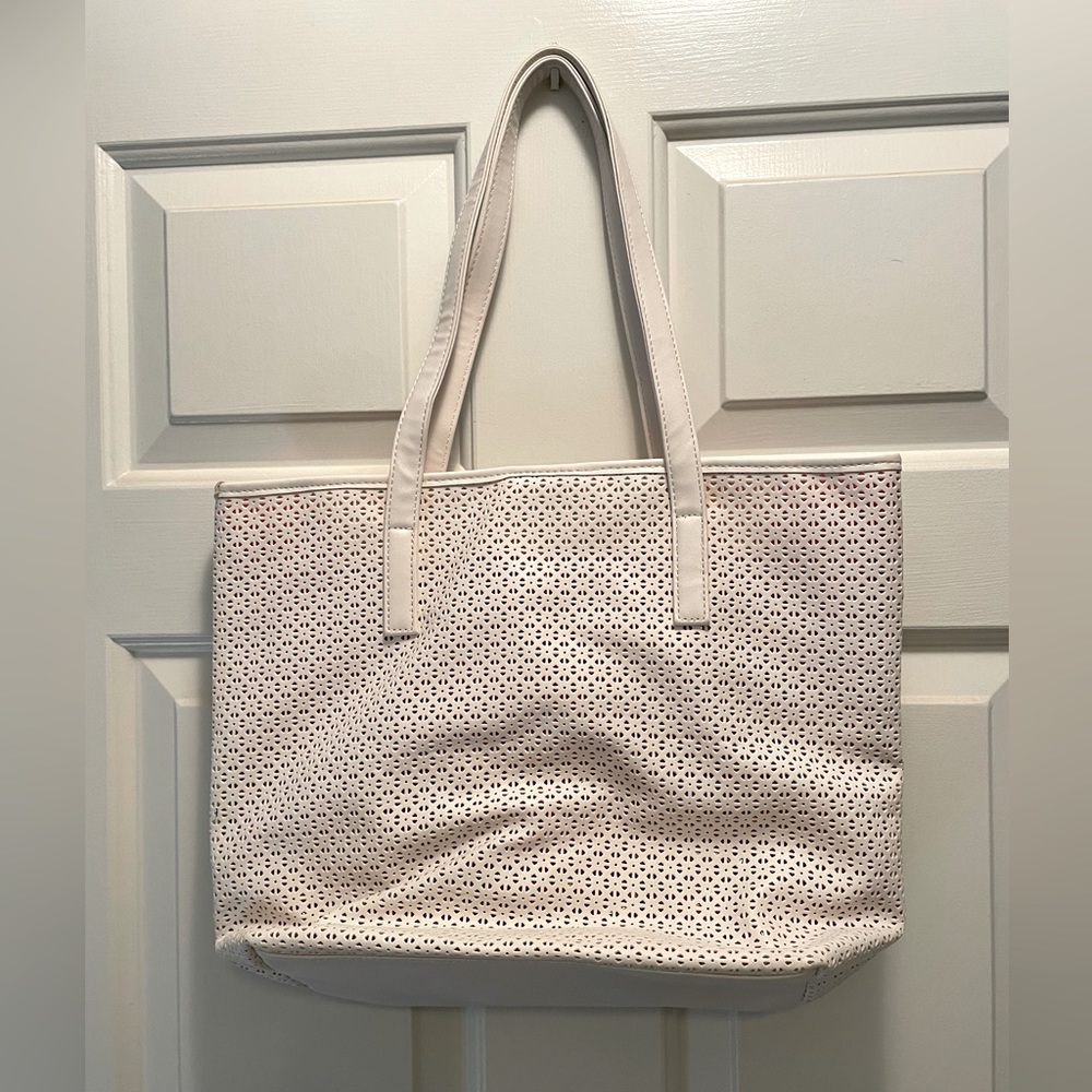 White leather shoulder purse with shoulder straps.